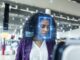 Woman interacting with facial recognition technology.