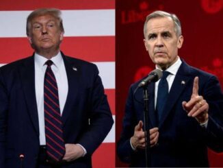 Two men standing, one speaking at podium.
