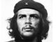 Man wearing beret with star, looking upwards.