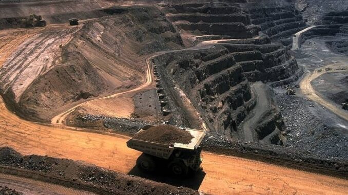 Mining truck in a large open-pit mine. Mining truck in a large open-pit mine.