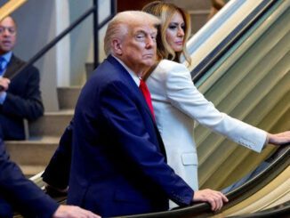 People on escalator in formal attire.