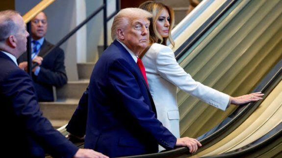 People on escalator in formal attire.