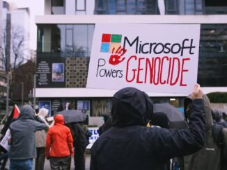 Protesters holding "Microsoft Powers Genocide" sign.