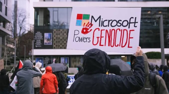 Protesters holding "Microsoft Powers Genocide" sign.