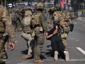 Soldiers detaining person during street protest.