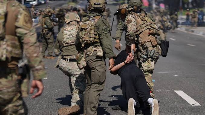 Soldiers detaining person during street protest. Soldiers detaining person during street protest.