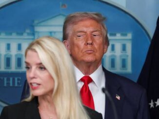 Two people at a press conference podium.