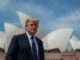 Man in suit with Sydney Opera House background.