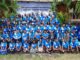Group photo at Pacific symposium, blue shirts.