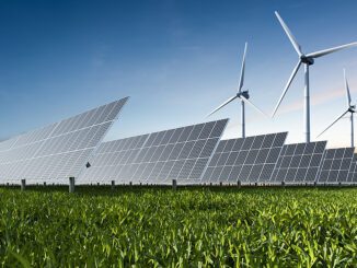 Solar panels and wind turbines in field.