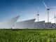 Solar panels and wind turbines in field.