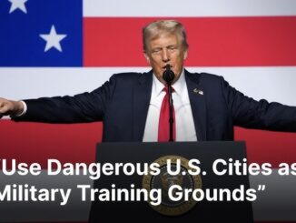 Person speaking at podium, American flag background.