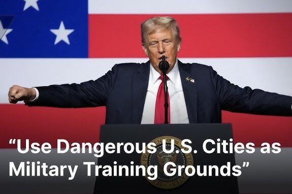Person speaking at podium, American flag background. Person speaking at podium, American flag background.