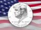 Coin with profile, American flag background.