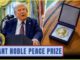 Man speaking beside Nobel Peace Prize medal.