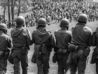 Soldiers facing crowd during protest.