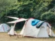 Camping tents with sleeping bag in forest.