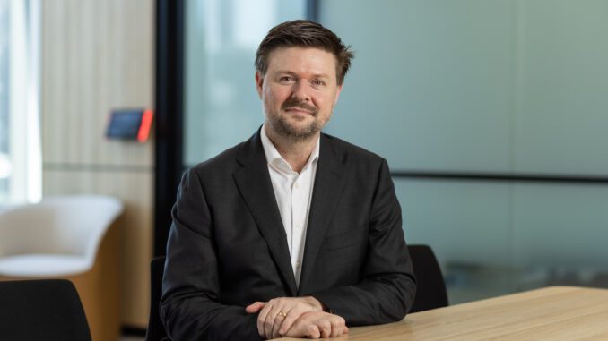 Man in suit sitting at wooden table. Man in suit sitting at wooden table.