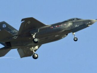 Jet fighter flying in clear blue sky.
