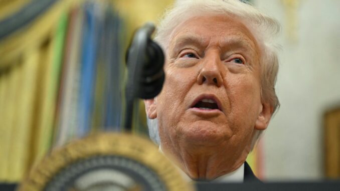 Man speaking at a podium with microphone.