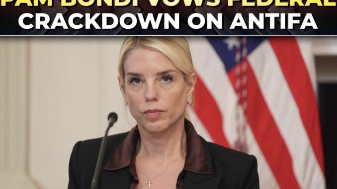 Woman speaking, U.S. flag background, announcement headline.
