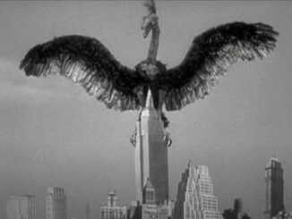 Giant bird atop skyscraper in black-and-white.