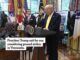 President speaking at podium in Oval Office.