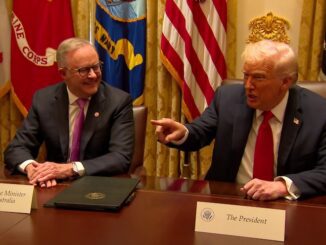 Two men sitting at a conference table.