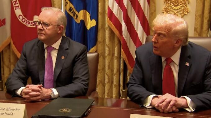 Two officials seated at a conference table.