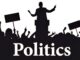 Silhouetted politician and crowd with signs.