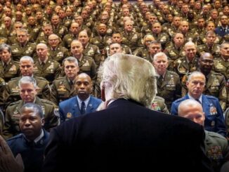 Back view of speaker addressing military audience.