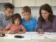 Family reviewing documents at a table.