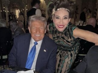Two people smiling at a formal event.