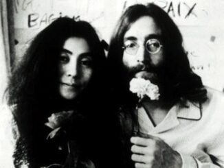 Couple holding flowers, black and white photo.