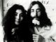 Couple holding flowers, black and white photo.