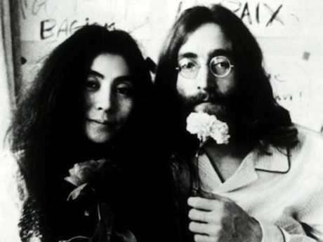 Couple holding flowers, black and white photo.