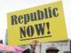 Protester holding "Republic NOW!" sign outdoors.