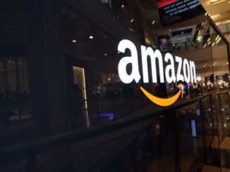 Amazon logo on a glass-walled building.