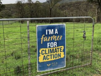 Sign on gate: "I'm a Farmer for Climate Action.