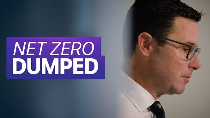 Man beside "Net Zero Dumped" text. Man beside "Net Zero Dumped" text.