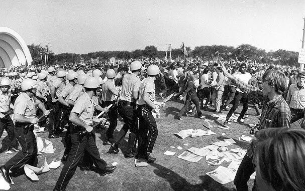Police confronting protesters in a park. Police confronting protesters in a park.