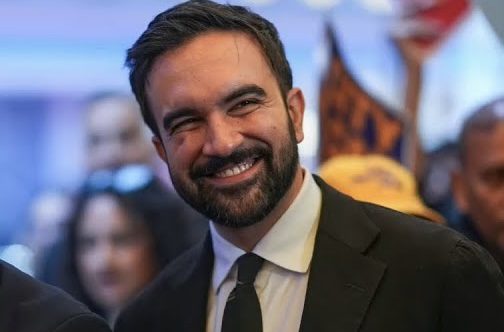 Bearded man in dark suit smiling at gathering Bearded man in dark suit smiling at gathering