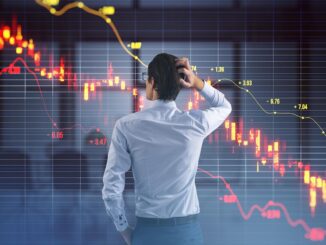 Man analyzing downward stock market graph.