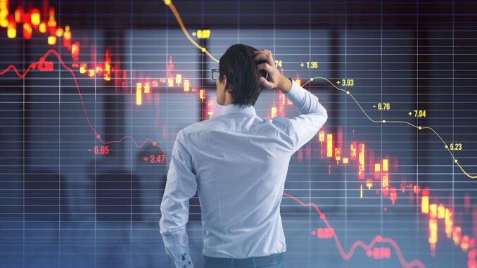 Man analyzing downward stock market graph. Man analyzing downward stock market graph.