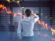 Man analyzing downward stock market graph.