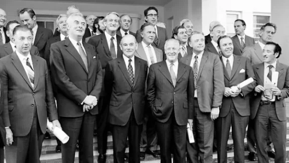 Group of men in suits, black and white.