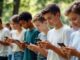 Teens using smartphones outdoors in a park.