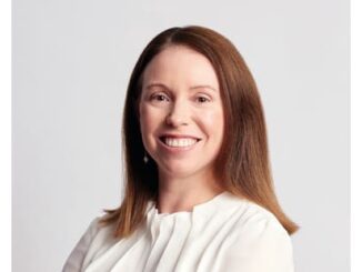 Smiling woman in white blouse portrait.