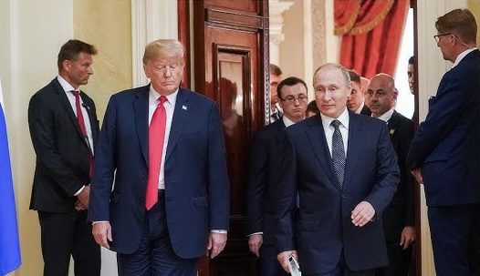 Two men walking through a doorway together.