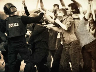 Police clashing with protestors in sepia tone.